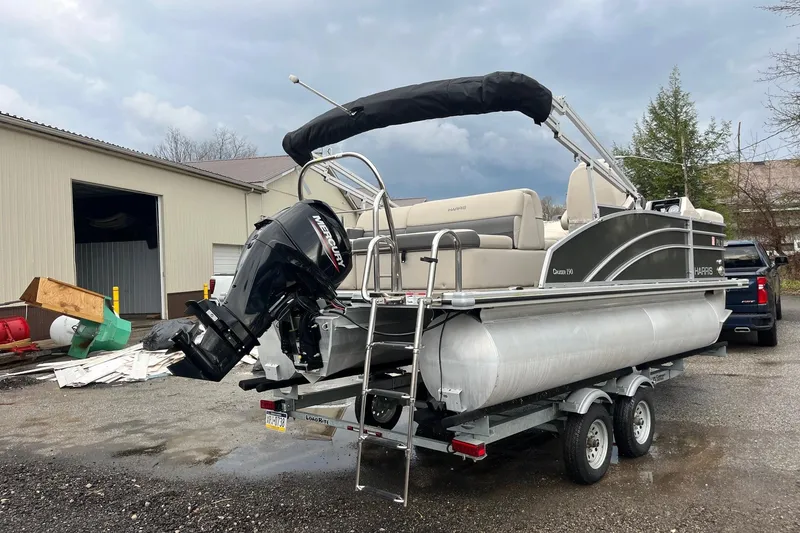 Slide: The Image of 2023 Harris Cruiser 190 pontoon boat on trailer, exterior view. - 3