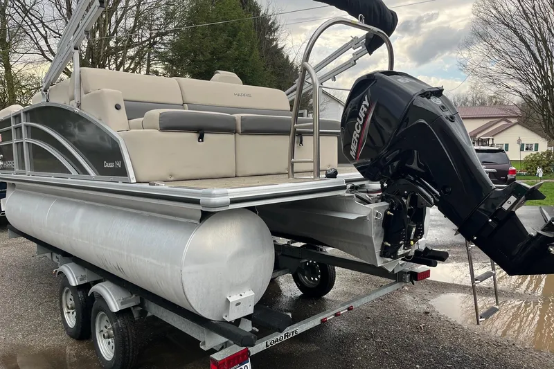 Slide: The Image of 2023 Harris Cruiser 190 pontoon boat on trailer with Mercury engine. - 4