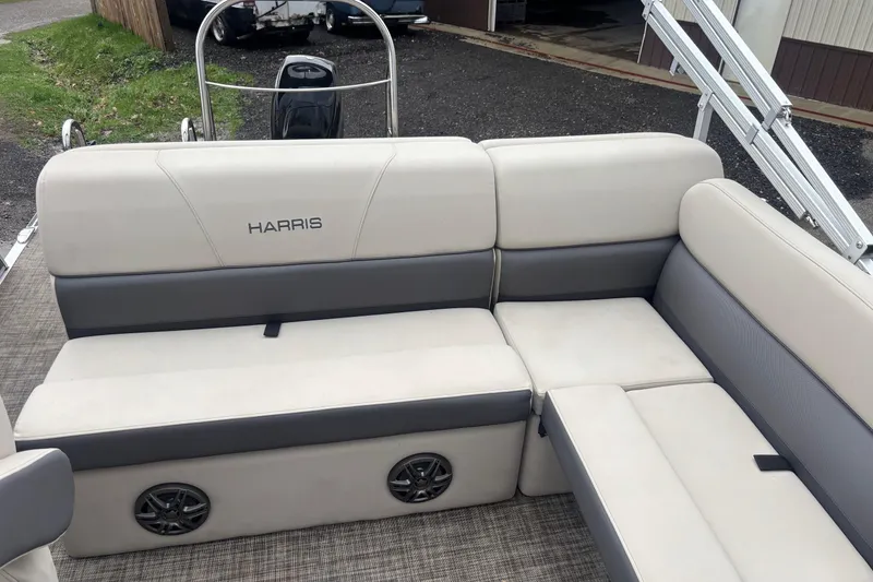 Slide: The Image of 2023 Harris Cruiser 190 pontoon boat with beige and gray seating area. - 6