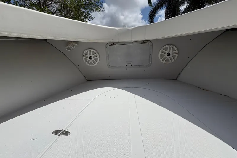 Slide: The Image of Interior view of a 2002 Ocean Runner 30 boat with speakers and storage compartment. - 13