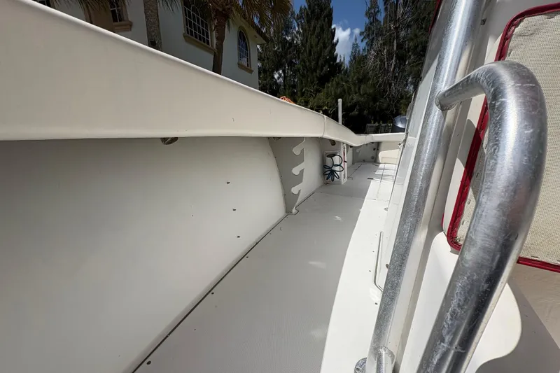 Slide: The Image of 2002 Ocean Runner 30 boat interior with white deck and railing. - 14
