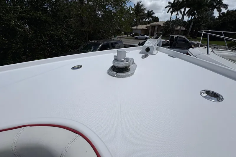 Slide: The Image of Bow of a 2002 Ocean Runner 30 boat with anchor mount, surrounded by trees and parked cars. - 15