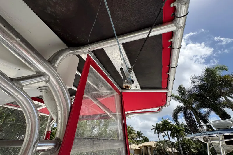 Slide: The Image of Close-up of Ocean Runner 30 boat canopy and frame, 2002 model, with palm trees in background. - 17