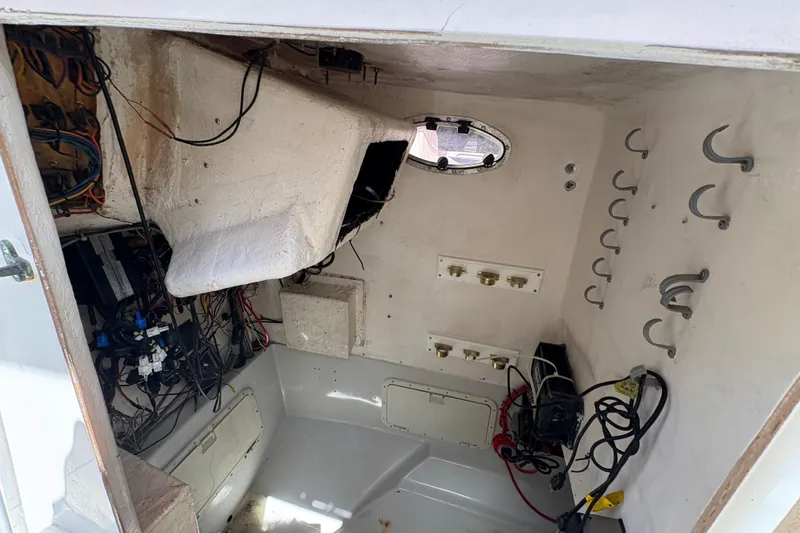 Slide: The Image of Interior of a 2002 Ocean Runner 30 boat showing wiring and storage hooks. - 18