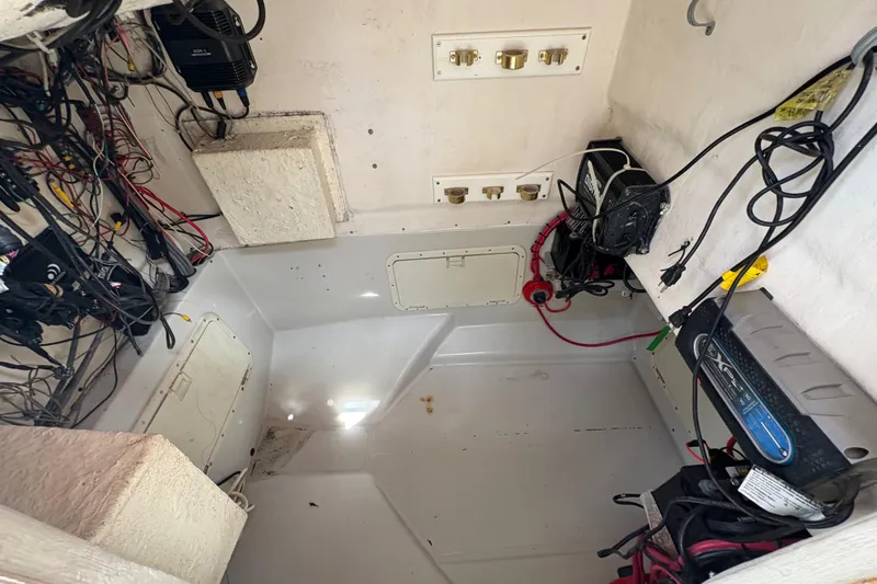 Slide: The Image of Interior of a 2002 Ocean Runner 30 boat showing wiring and electrical components. - 19