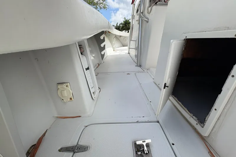 Slide: The Image of 2002 Ocean Runner 30 boat deck with open storage compartments and clean white surface. - 24