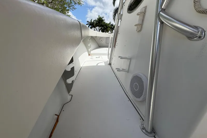 Slide: The Image of 2002 Ocean Runner 30 boat deck with railing and speaker, under a blue sky. - 25