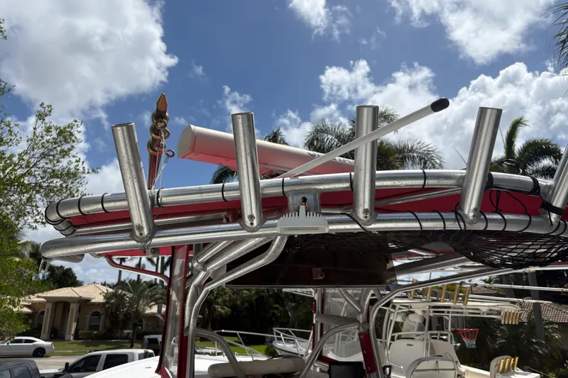 Slide: The Image of T-top of a 2002 Ocean Runner 30 boat with rod holders under a blue sky. - 28