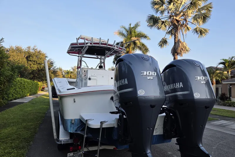 Slide: The Image of 2002 Ocean Runner 30 boat with twin Yamaha 300 V6 engines, parked on a residential street. - 3