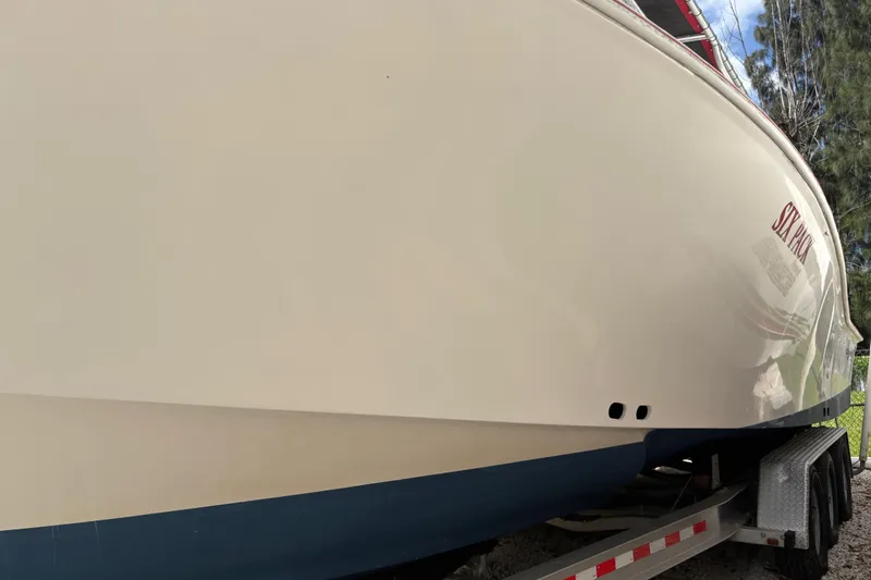 Slide: The Image of Side view of a 2002 Ocean Runner 30 boat on a trailer. - 30