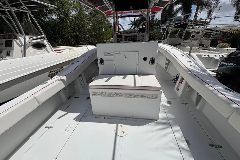 Slide: The Image of 2002 Ocean Runner 30 boat interior with seating and console, docked among other boats. - 6