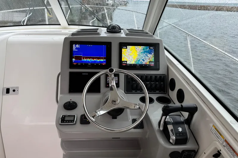 Slide: The Image of Helm of 2016 Boston Whaler 315 Conquest with navigation screens and controls. - 19