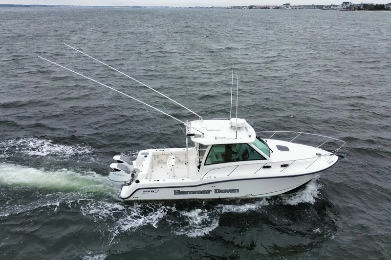 Slide: The Image of 2016 Boston Whaler 315 Conquest boat cruising on open water. - 3