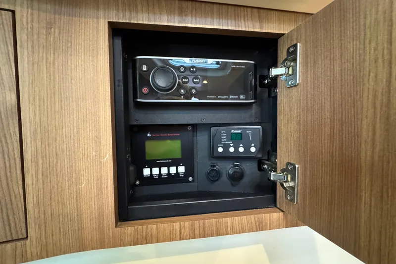 Slide: The Image of Control panel inside a 2016 Boston Whaler 315 Conquest boat, featuring audio and system controls. - 33