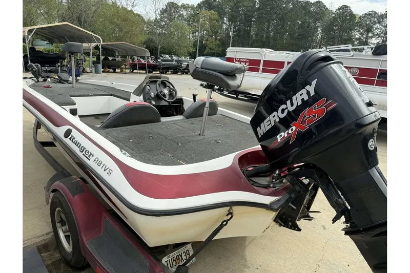 Slide: The Image of 2000 Ranger R81 boat with Mercury Pro XS engine, parked outdoors. - 10