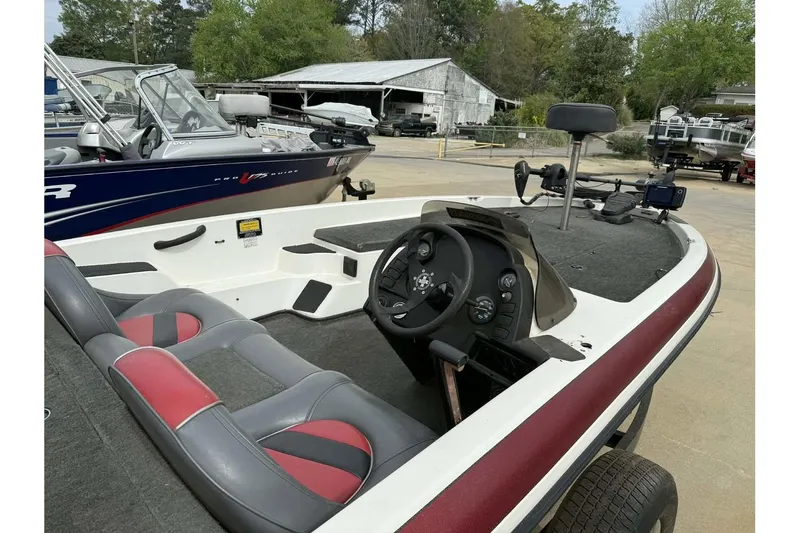 Slide: The Image of Interior view of a 2000 Ranger R81 boat with steering console and seating. - 8