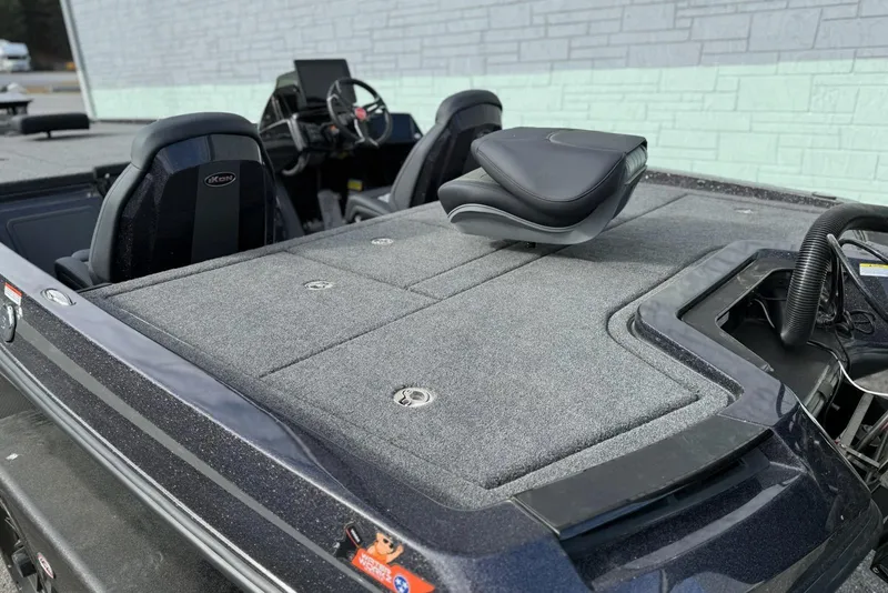 Slide: The Image of 2026 iKon LXE20 boat interior with cushioned seating and steering console. - 11