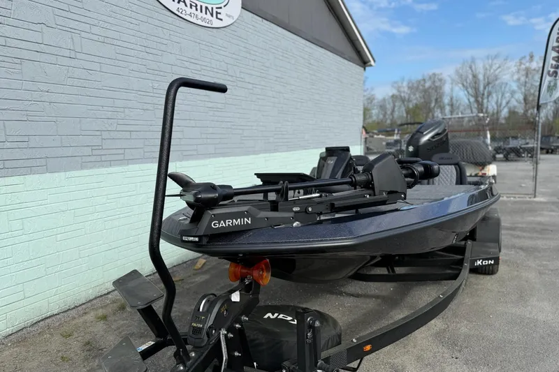 Slide: The Image of 2026 iKon LXE20 boat with Garmin equipment on trailer, parked outside a marine shop. - 2