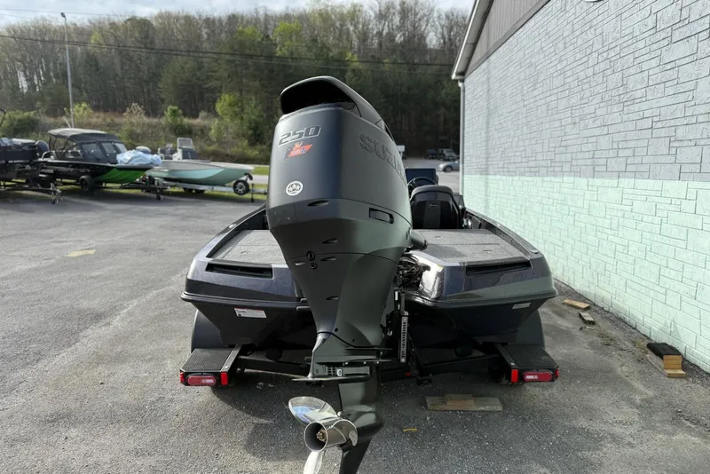 Slide: The Image of 2026 iKon LXE20 boat with powerful outboard motor in a parking area. - 5