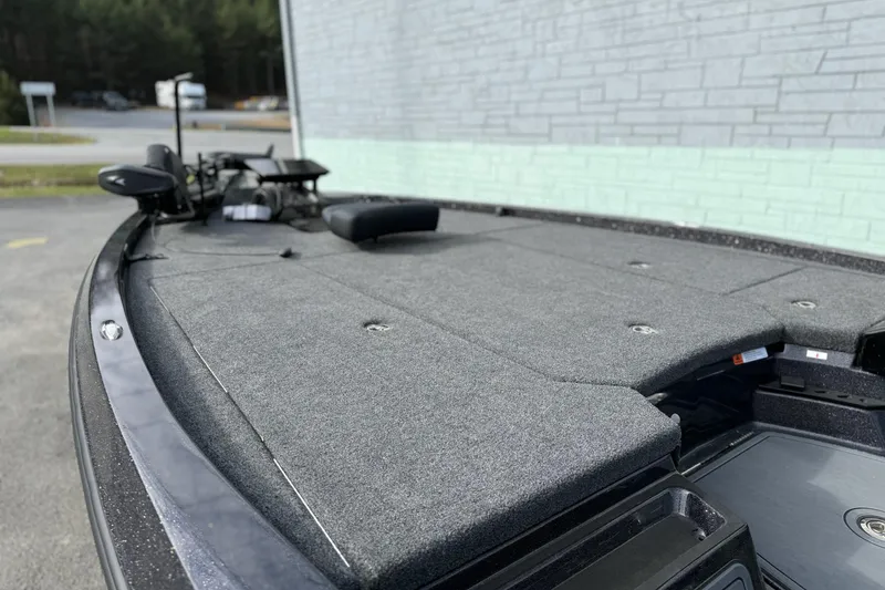 Slide: The Image of 2026 iKon LXE20 boat deck with carpeted surface and fishing equipment. - 6