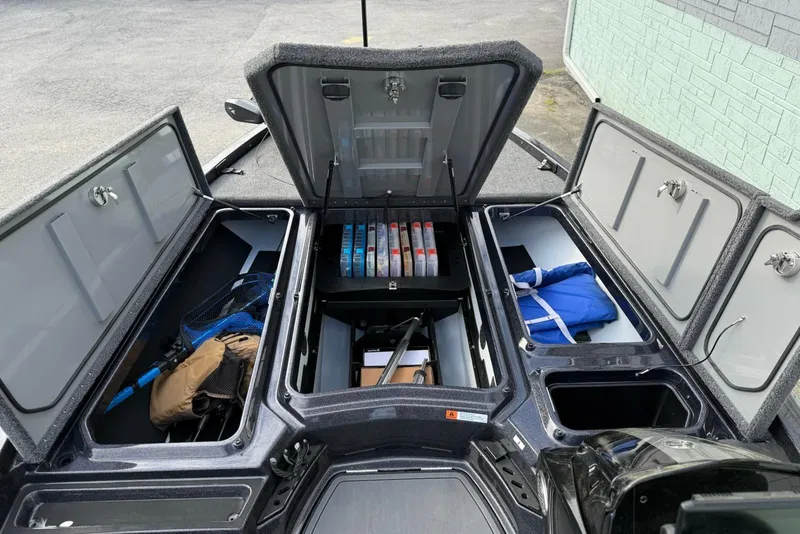 Slide: The Image of Open storage compartments on a 2026 iKon LXE20 boat, showcasing organized fishing gear and equipment. - 8