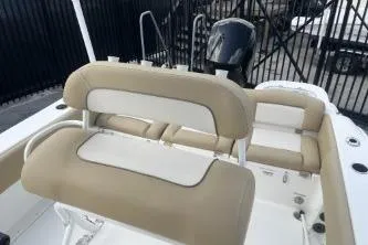 Slide: The Image of 2023 NauticStar 2302 Legacy boat interior with beige seating and modern design. - 11
