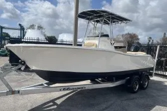Slide: The Image of 2023 NauticStar 2302 Legacy boat on trailer, parked outdoors. - 4