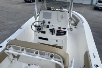 Slide: The Image of 2023 NauticStar 2302 Legacy boat interior with steering console and seating. - 7