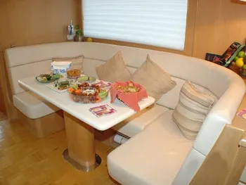 Slide: The Image of Interior of Hatteras 74 Sport Deck Yacht, dining area with food. - 3