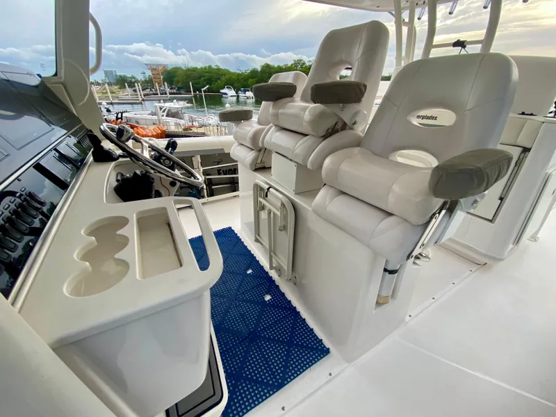 Slide: The Image of Interior of 2016 Everglades 435 Center Console boat with helm seating and controls. - 10