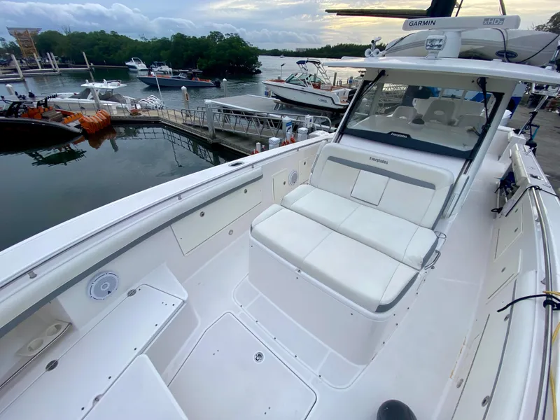Slide: The Image of 2016 Everglades 435 Center Console boat docked, featuring spacious seating and sleek design. - 17