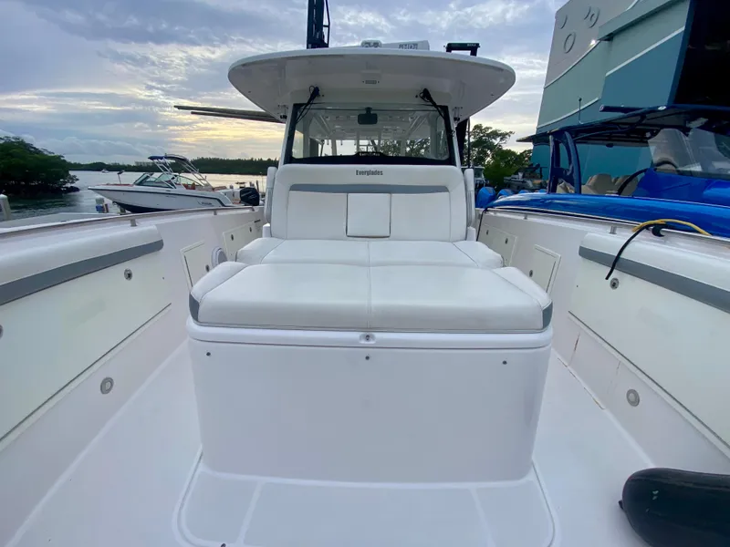 Slide: The Image of 2016 Everglades 435 Center Console boat with spacious seating, docked at marina. - 18