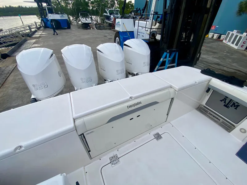 Slide: The Image of 2016 Everglades 435 Center Console boat with four powerful outboard engines docked. - 4