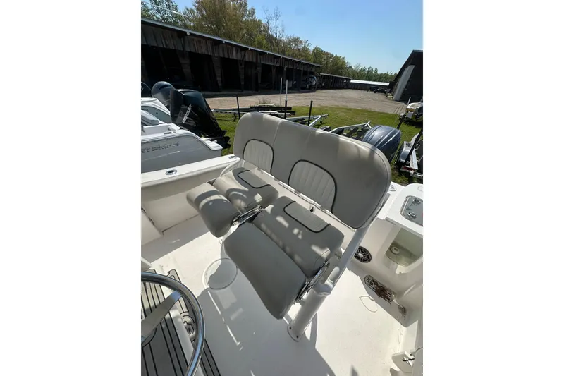 Slide: The Image of 2023 Sea Fox 228 Commander boat interior with cushioned seating and steering wheel. - 15