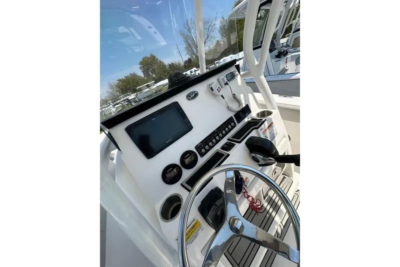 Slide: The Image of 2023 Sea Fox 228 Commander boat dashboard with steering wheel and navigation controls. - 17