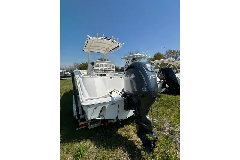 Slide: The Image of 2023 Sea Fox 228 Commander boat with Yamaha 150 engine, parked on grass. - 6