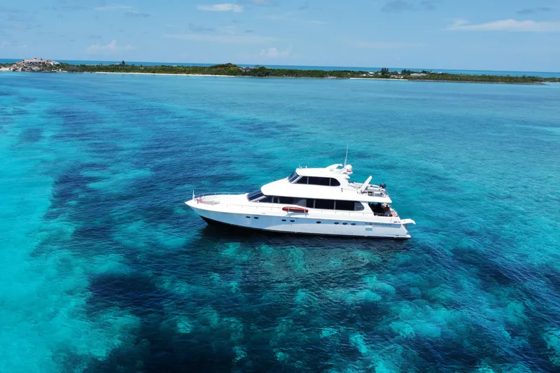 Slide: The Image of Lazzara 76 Skylounge Grand Salon yacht cruising in clear blue waters, 1998 model. - 1