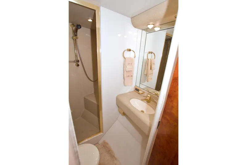 Slide: The Image of Luxurious bathroom in 1998 Lazzara 76 Skylounge Grand Salon yacht with gold fixtures. - 101