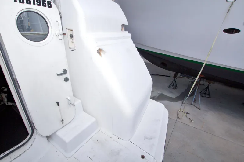 Slide: The Image of 1998 Lazzara 76 Skylounge Grand Salon yacht exterior with open door and visible hull. - 105