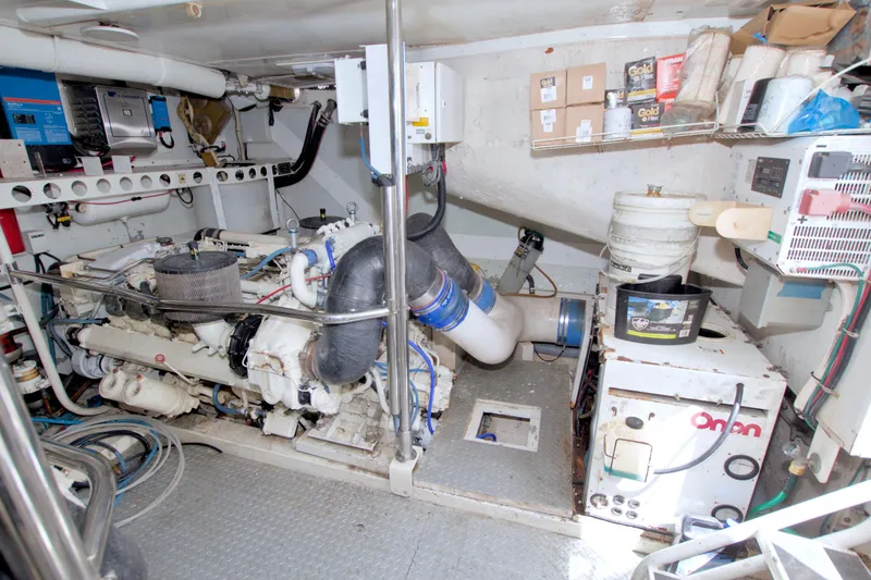 Slide: The Image of Engine room of 1998 Lazzara 76 Skylounge Grand Salon yacht, featuring machinery and storage. - 107