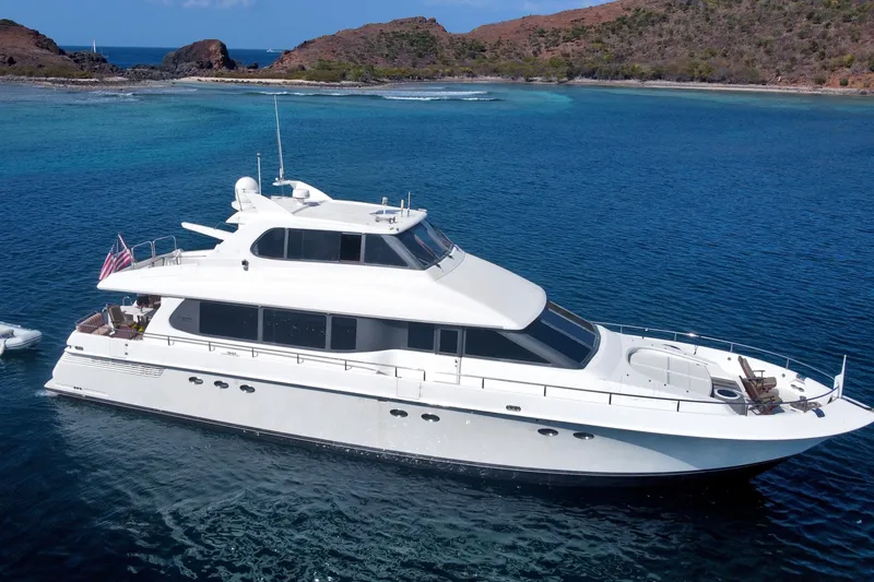 Slide: The Image of Luxury 1998 Lazzara 76 Skylounge Grand Salon yacht cruising in clear blue waters. - 133