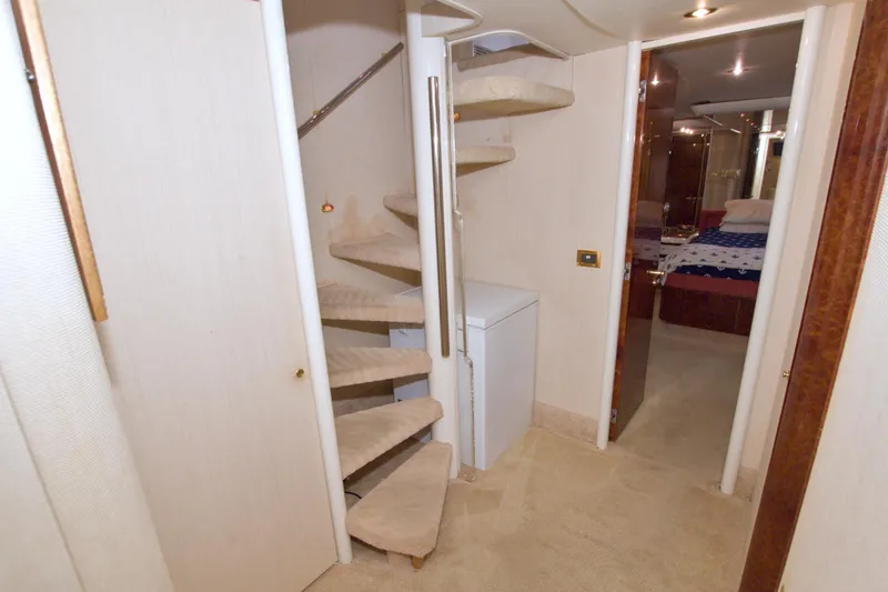 Slide: The Image of Interior of 1998 Lazzara 76 Skylounge Grand Salon with spiral staircase and bedroom view. - 17