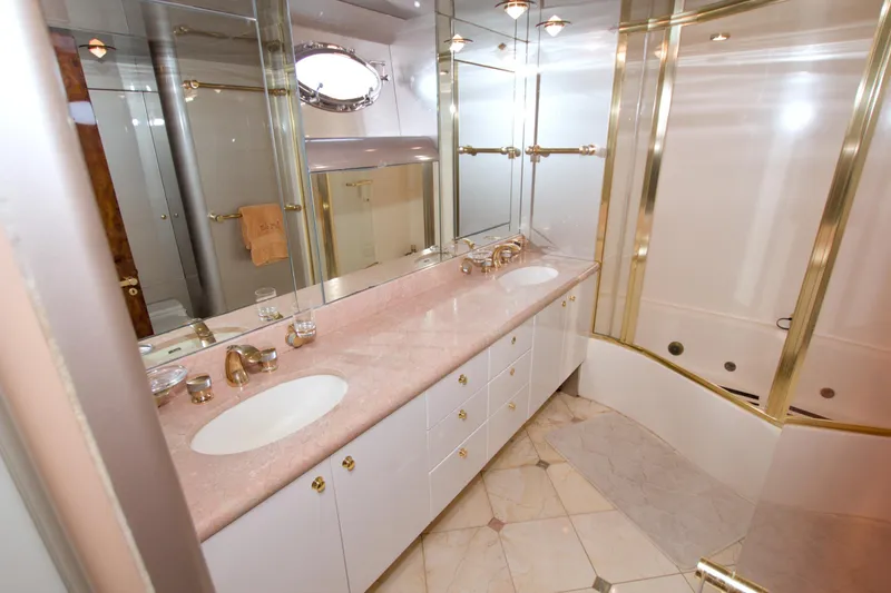 Slide: The Image of Luxurious bathroom in 1998 Lazzara 76 Skylounge Grand Salon yacht with dual sinks and gold accents. - 22
