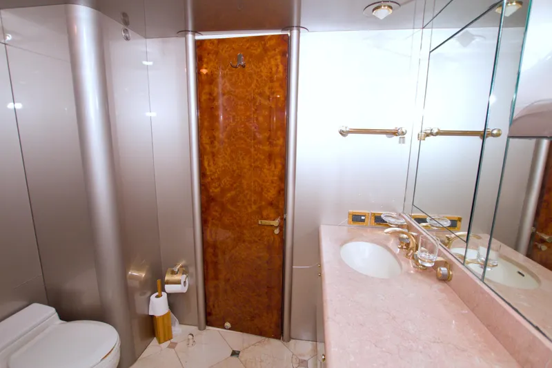 Slide: The Image of Luxurious bathroom in 1998 Lazzara 76 Skylounge Grand Salon yacht, featuring elegant fixtures and marble countertop. - 26