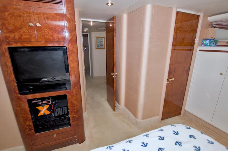 Slide: The Image of Luxurious interior of 1998 Lazzara 76 Skylounge Grand Salon yacht with wood paneling and TV. - 30