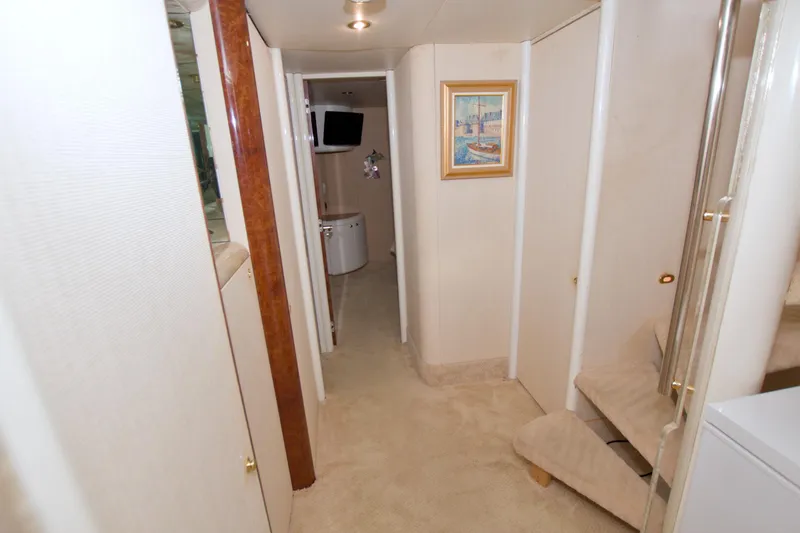 Slide: The Image of Interior hallway of 1998 Lazzara 76 Skylounge Grand Salon yacht, featuring elegant decor. - 31