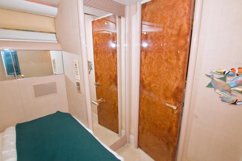 Slide: The Image of Interior of 1998 Lazzara 76 Skylounge Grand Salon with wood door and wall art. - 34