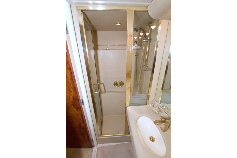 Slide: The Image of Luxurious bathroom with gold accents in 1998 Lazzara 76 Skylounge Grand Salon yacht. - 36