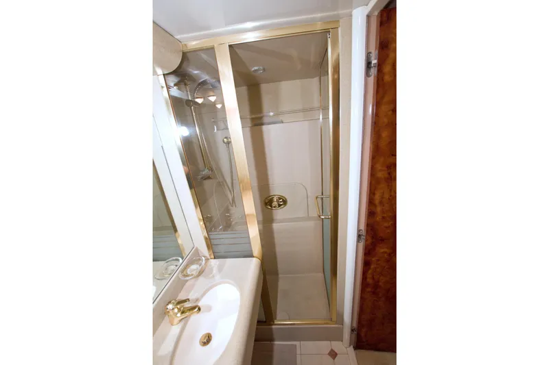 Slide: The Image of Luxurious bathroom with gold accents in 1998 Lazzara 76 Skylounge Grand Salon yacht. - 42
