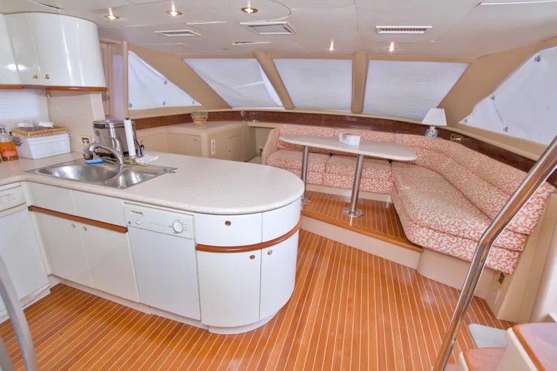 Slide: The Image of Luxurious interior of 1998 Lazzara 76 Skylounge Grand Salon yacht with kitchen and seating area. - 49